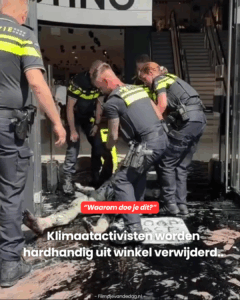 Klimaatactivisten worden hardhandig uit winkel verwijderd..